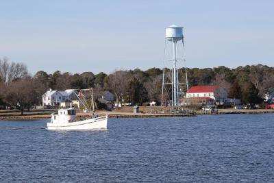 Boat on the water about to pass the water tower